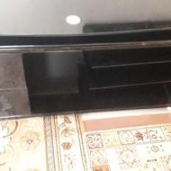 میز زیر تلویزونی پایه دار رو شیشه ای